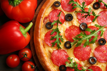 Tasty pizza with salami background, close up
