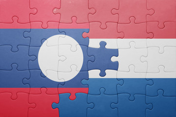 puzzle with the national flag of netherlands and laos