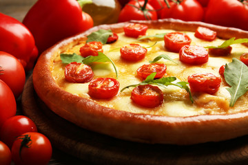 Pizza Margherita with arugula, red pepper, tomatoes, close-up