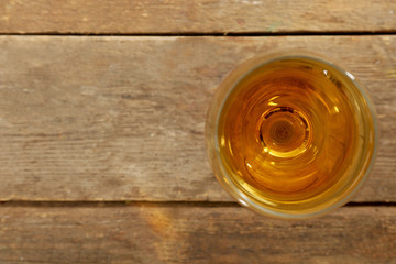Glass of wine on wooden table. Top view