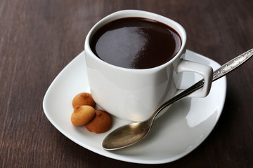 Cacao with biscuits on wooden background