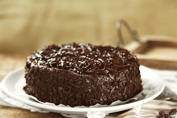 Tasty chocolate cake on wooden background