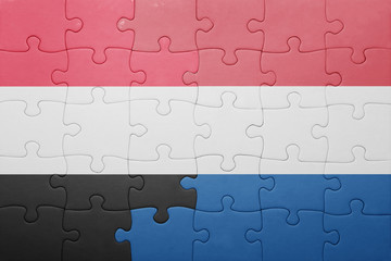 Fototapeta premium puzzle with the national flag of netherlands and yemen