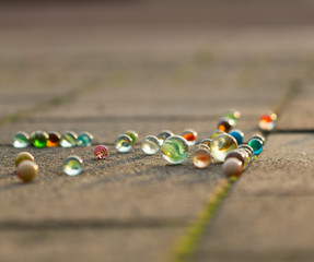 Marbles on the sidewalk in golden sunlight.
Diversity of colors.