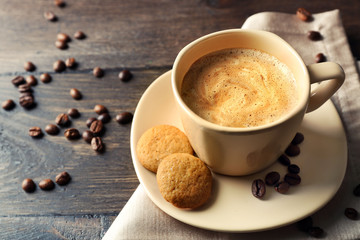 Cup of coffee on wooden table background