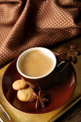 Cup of coffee on tray, on wooden table background