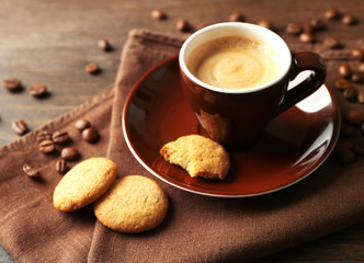 Cup of coffee on wooden table background