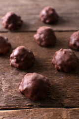 Chocolate sweets on wooden background