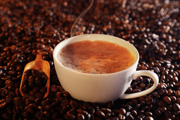 Cup of coffee and coffee beans closeup