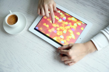 Woman using digital tablet on table close up