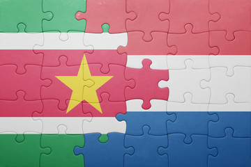 puzzle with the national flag of netherlands and suriname