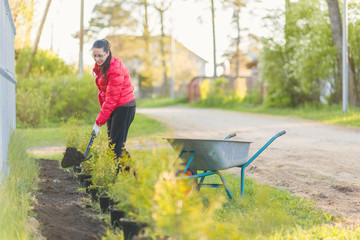 Young beautiful woman in her garden