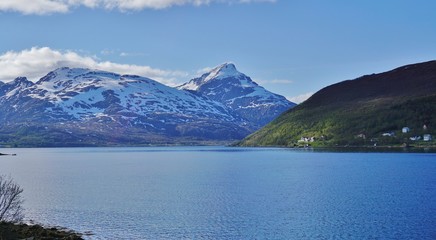 Norwegian landscape around Tromso with mountains and lakes under the midnight sun