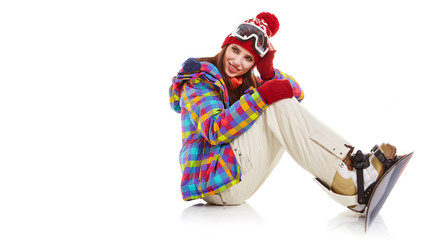 Young woman sitting on floor with snowboard