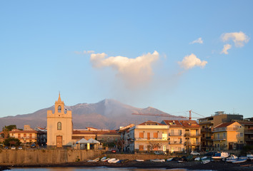 Etna with the smoking peak above the Italian town Acireale