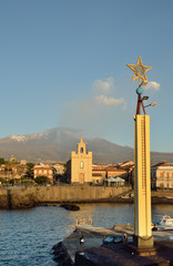 Etna with the smoking peak above the Italian town Acireale