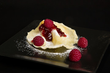 Pancake with raspberry sauce.