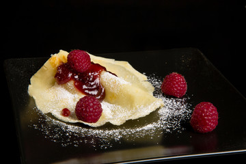 Pancake with raspberry sauce.