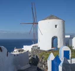 Fototapeta na wymiar An old Greek windmill in Oia town on the island of Santorini, Greece