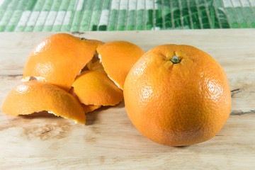 Orange and peel on wooden block