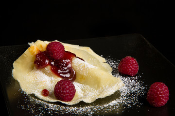 Pancake with raspberry sauce.