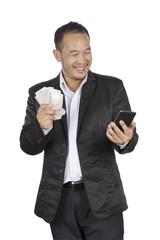 Young businessman holding banknote and cellphone