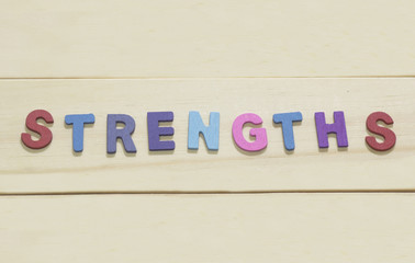 The colorful word "Strengths " on wood background : SWOT Concept