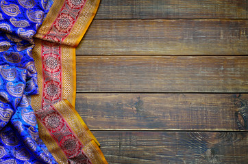 Old boards and fabric with traditional east ornaments paisley. - obrazy, fototapety, plakaty