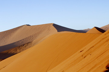 Fototapeta na wymiar The majestic red dune. Shot in Deadvlei, Naukluft National Park