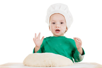 Smiling little boy kneading dough for the cookies, isolated on white