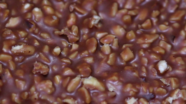 Chocolate bar with nut pieces.