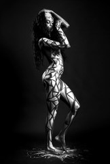 Fototapeta na wymiar African model body covered with painted polygons black and white