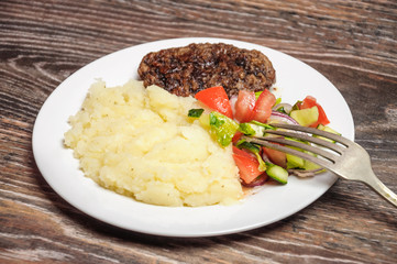 Fried cutlet, mashed potatoes and fresh vegetable salad