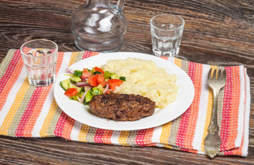 Fried cutlet, mashed potatoes and fresh vegetable salad