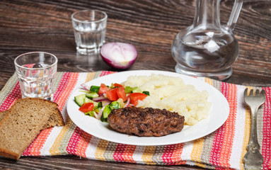 Fried cutlet, mashed potatoes and fresh vegetable salad