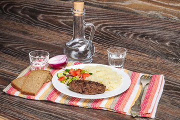 Fried cutlet, mashed potatoes and fresh vegetable salad
