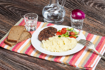 Fried cutlet, mashed potatoes and fresh vegetable salad
