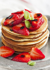 Stack of pancakes with fresh strawberry and balsamic glase