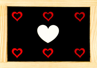 Wooden frame vintage chalkboard with seven red heart shape symbols, love concept