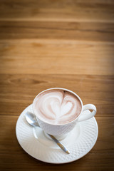 Hot art Latte Coffee in a cup on wooden table.