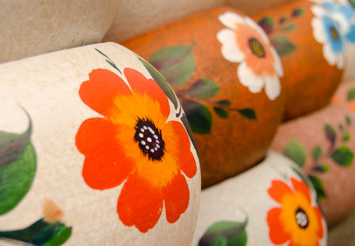 Mexican ceramic pots, rows of large orange flowers
