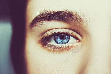 Naklejka premium An insightful beautiful look boy's blue eye