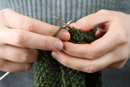 Women's hands  knit metal spokes. Knitting closeup.