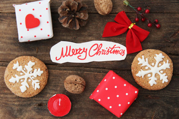 Christmas background with cookies, gift box, heart, pine cone, walnut, candle and ribbon