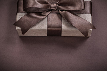 Gift box on brown background holidays concept