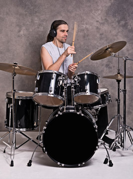 musician with his black drum set