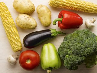 Raw multicolor vegetables closeup on the white wood table