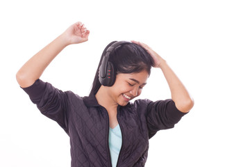 Portrait of young woman with headphones listening music. 