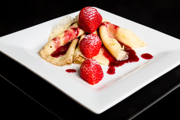 Pancake with strawberry sauce.