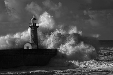 Infrared stormy waves over old lighthouse